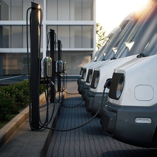 Several electric vehicles plugged into shared charging stations