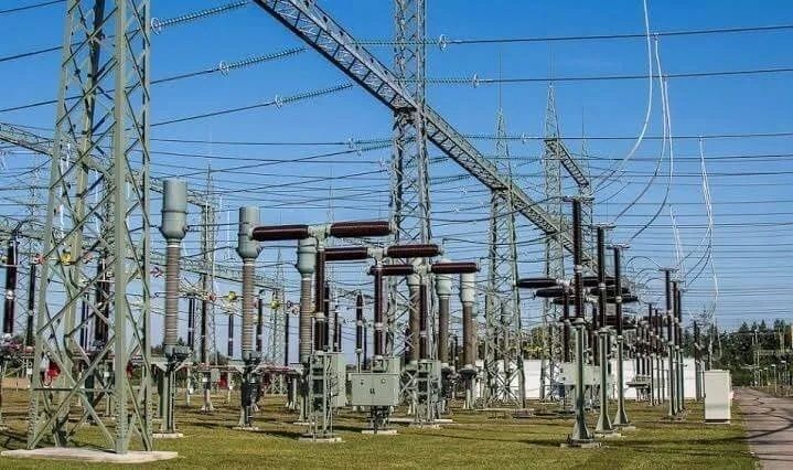 Electrical substation with transformers, towers, and overhead power lines